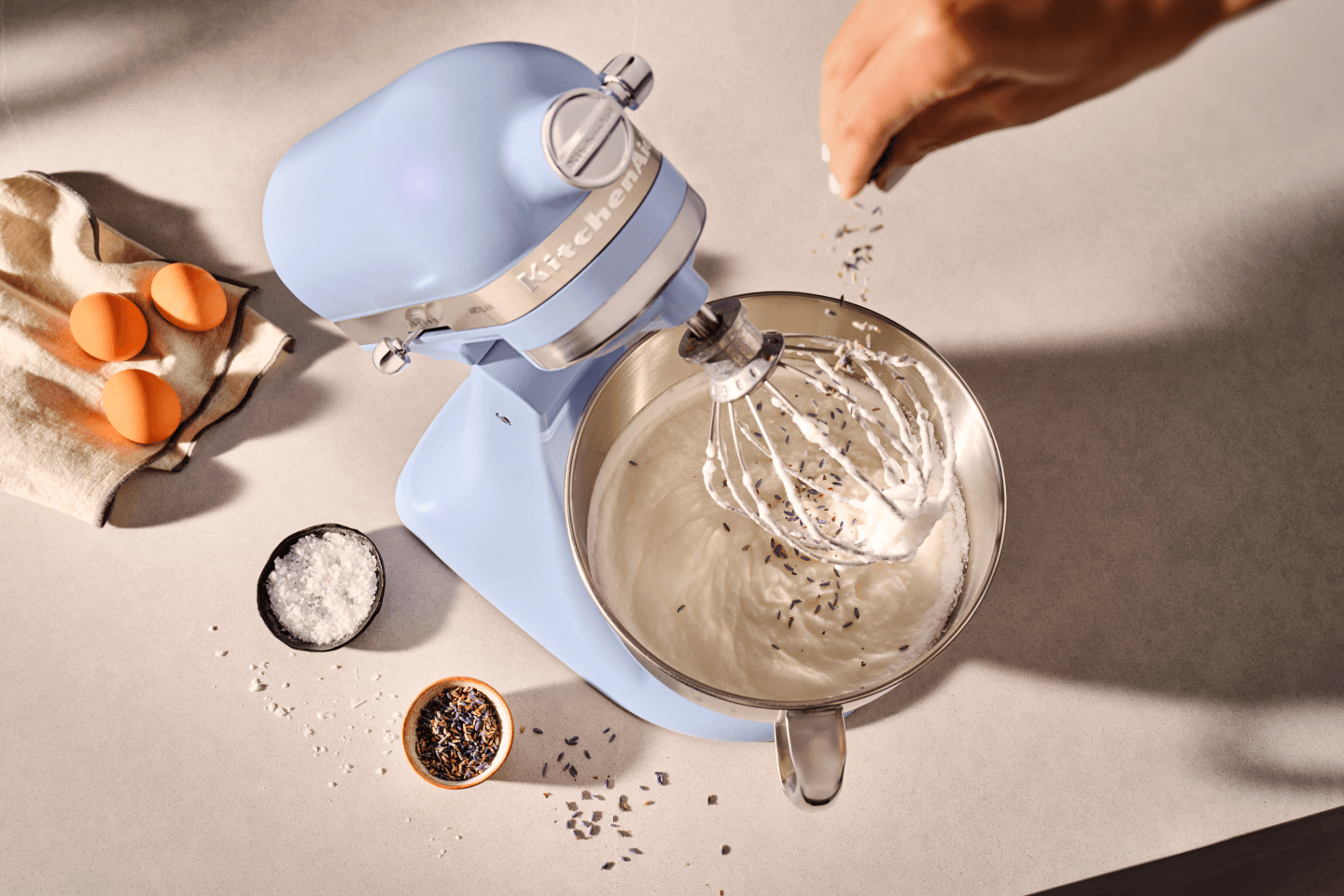 Person adding herbs to a KitchenAid® stand mixer in Blue Salt Person adding herbs to a KitchenAid® stand mixer in Blue Salt