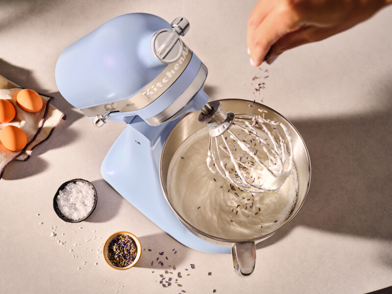Person adding herbs to a KitchenAid® stand mixer in Blue Salt Person adding herbs to a KitchenAid® stand mixer in Blue Salt