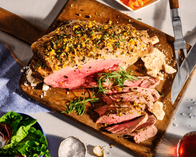 Seasoned meat on a wooden cutting board