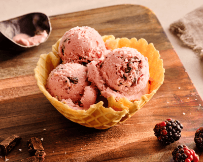Three scoops of ice cream in a waffle cone bowl