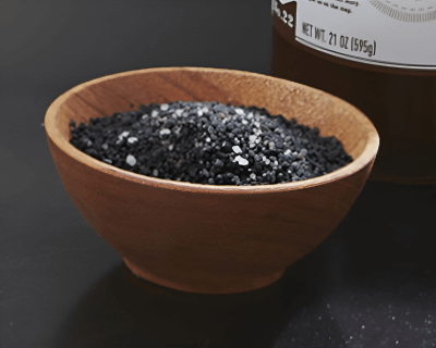 Wooden bowl filled with black salt