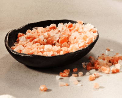 Black bowl filled with pink salt
