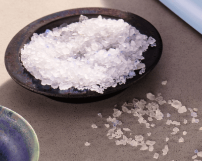 Wooden bowl filled with blue salt