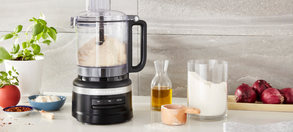 Black KitchenAid® food processor next to baking ingredients Black KitchenAid® food processor next to baking ingredients