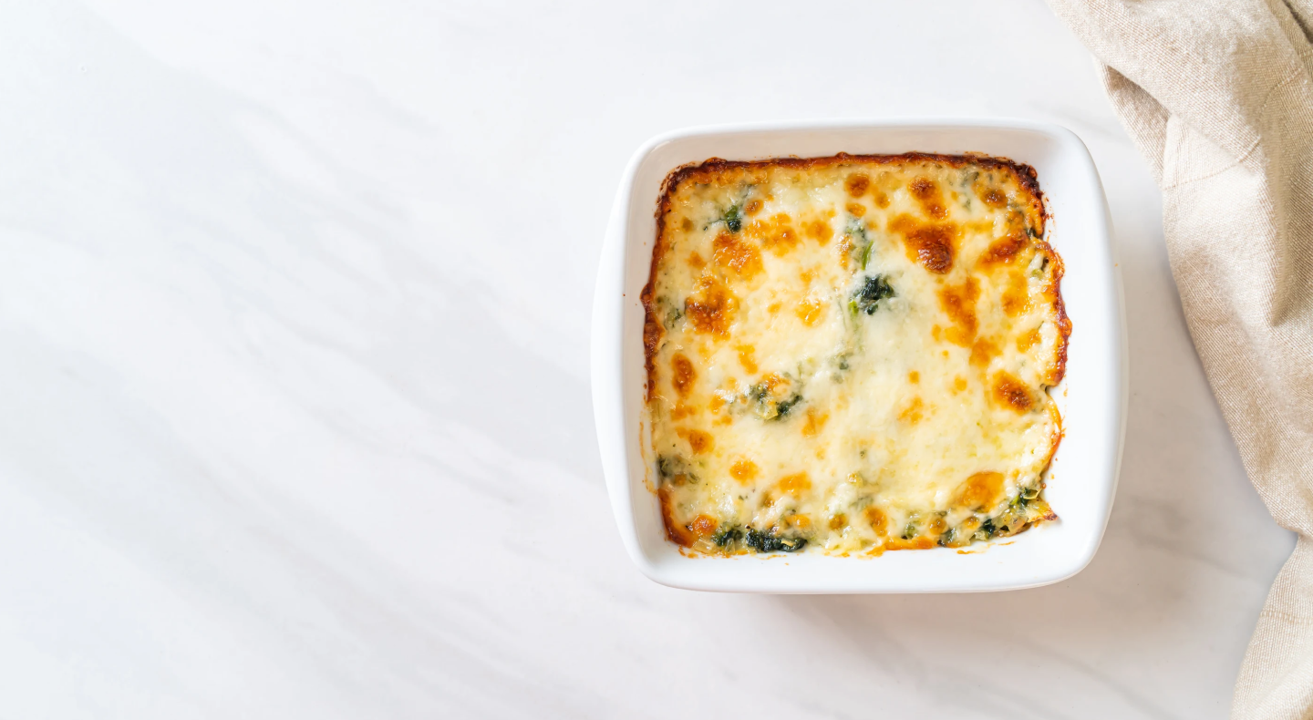 A cheesy-looking dip in a white dish A cheesy-looking dip in a white dish