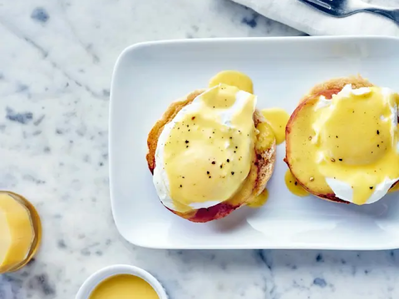 Toasted bagel with vegan eggs on a plate Toasted bagel with vegan eggs on a plate