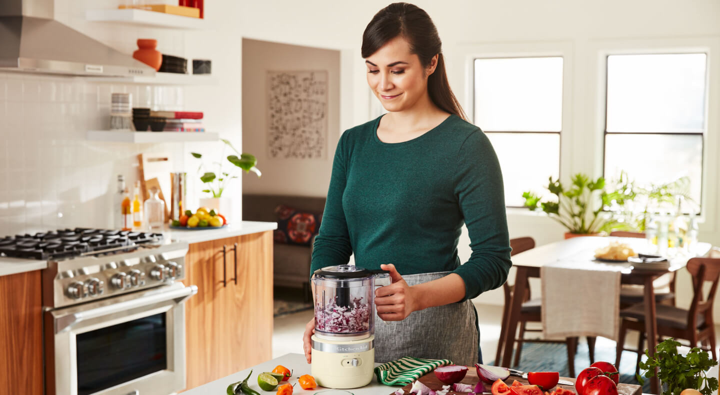 Person using a KitchenAid® cordless food chopper Person using a KitchenAid® cordless food chopper