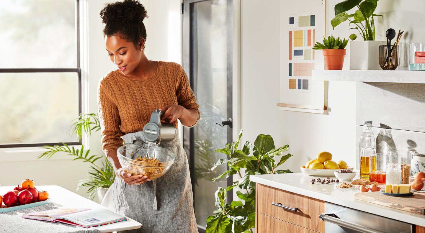 Person mixing ingredients with a KitchenAid® cordless hand mixer Person mixing ingredients with a KitchenAid® cordless hand mixer