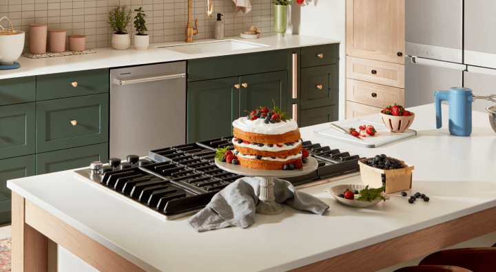 A modern kitchen with a cooktop on an island A modern kitchen with a cooktop on an island