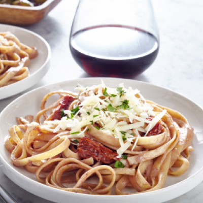 Fettuccine with meat sauce topped with shredded cheese