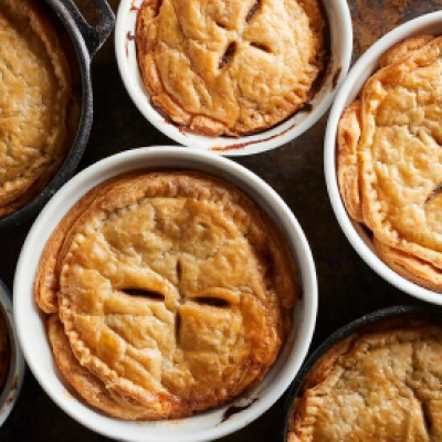 Several baked pie crusts in dishes