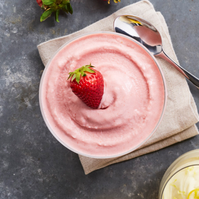 Bowl of Italian ice with strawberries and lemon