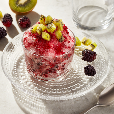 A cup of cherry shaved ice with watermelon slices