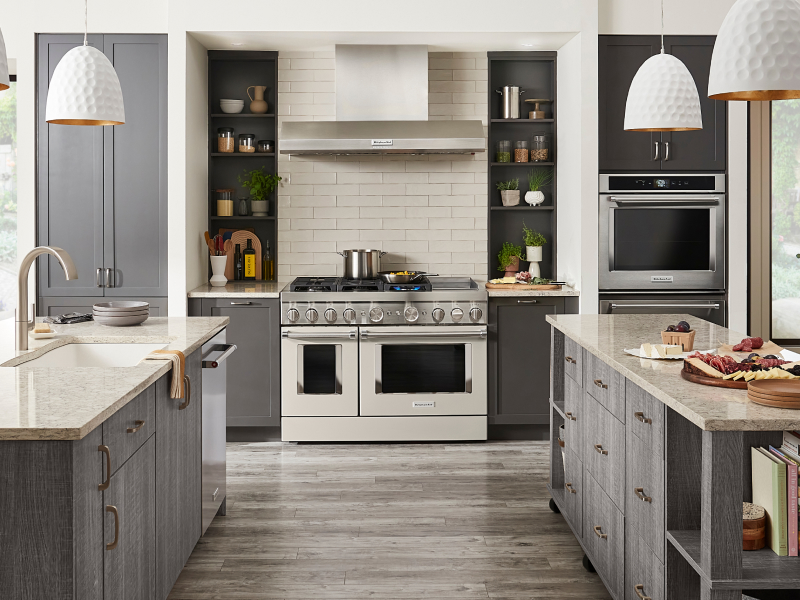 Kitchen with two islands, commercial style range and gray cabinets Kitchen with two islands, commercial style range and gray cabinets