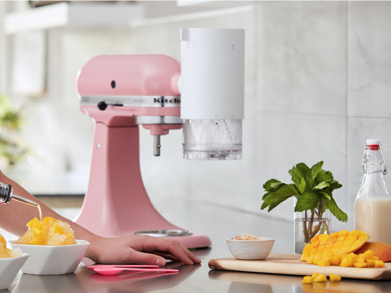 Person making mango flavored shaved ice with their KitchenAid® stand mixer. Person making mango flavored shaved ice with their KitchenAid® stand mixer.