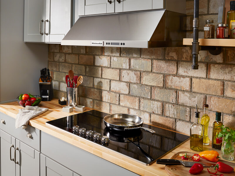 A kitchen with a smooth glass cooktop and wall oven A kitchen with a smooth glass cooktop and wall oven
