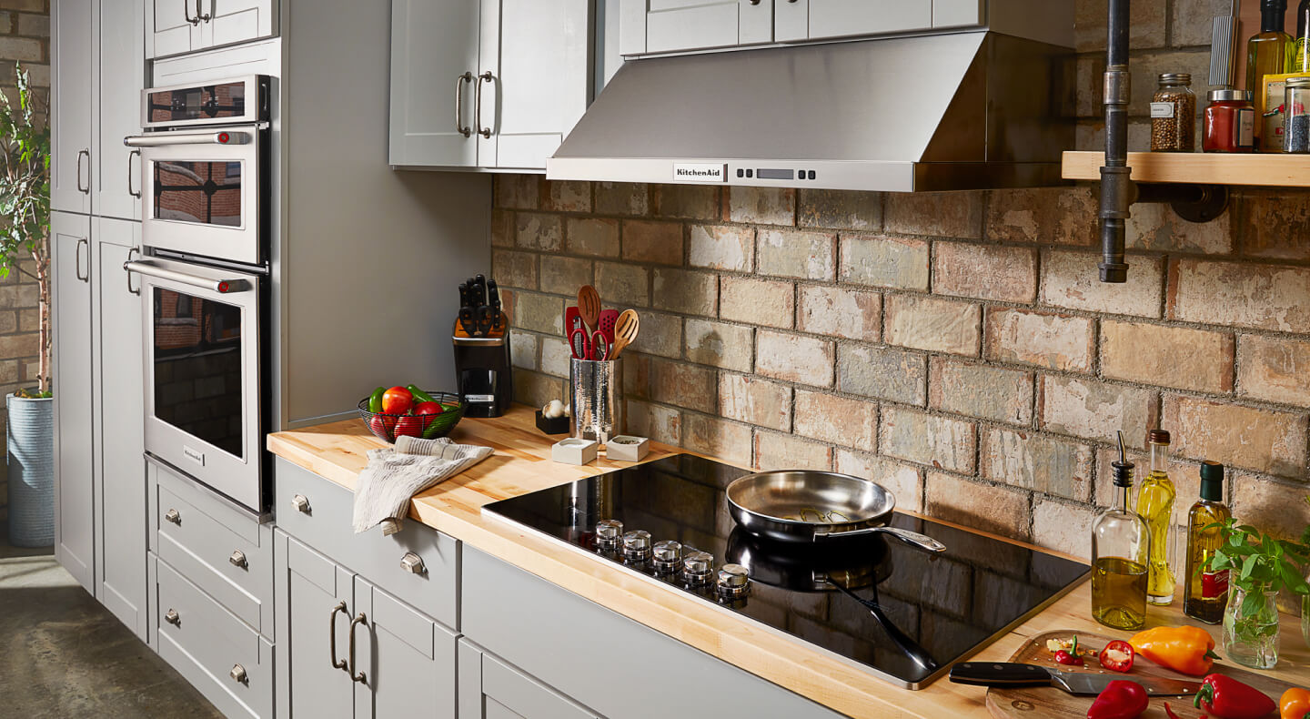 A kitchen with a smooth glass cooktop and wall oven A kitchen with a smooth glass cooktop and wall oven