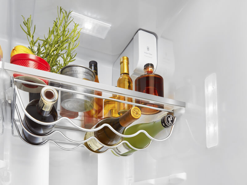 Opened side-by-side refrigerator with a fully-stocked interior Opened side-by-side refrigerator with a fully-stocked interior