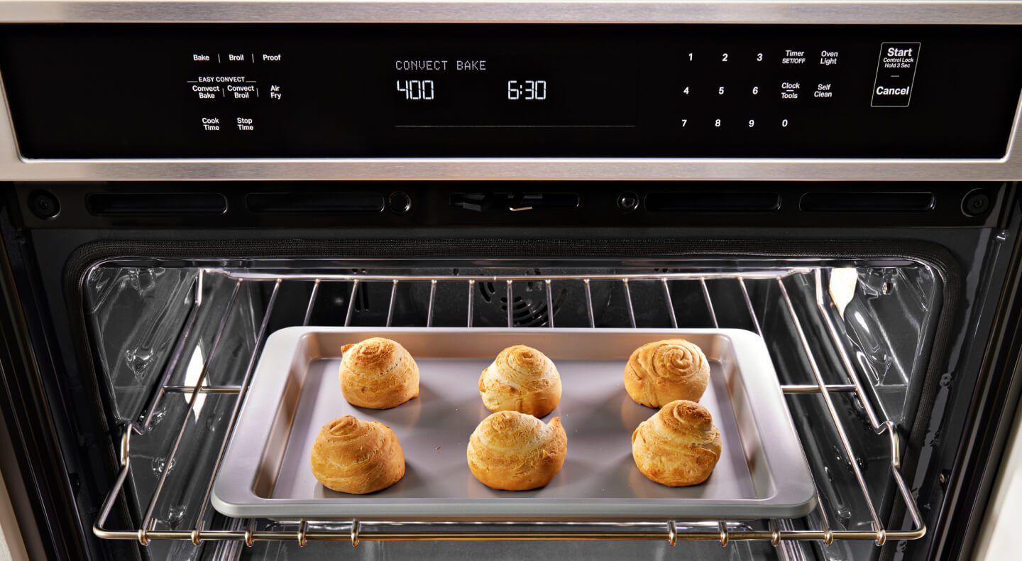 Close up image of bread rolls baking in an oven