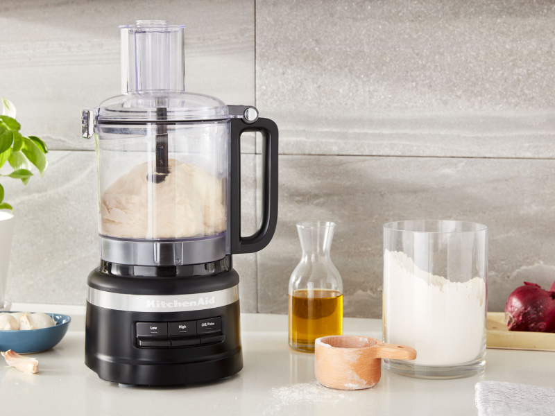 KitchenAid® food processor on counter next to ingredients KitchenAid® food processor on counter next to ingredients