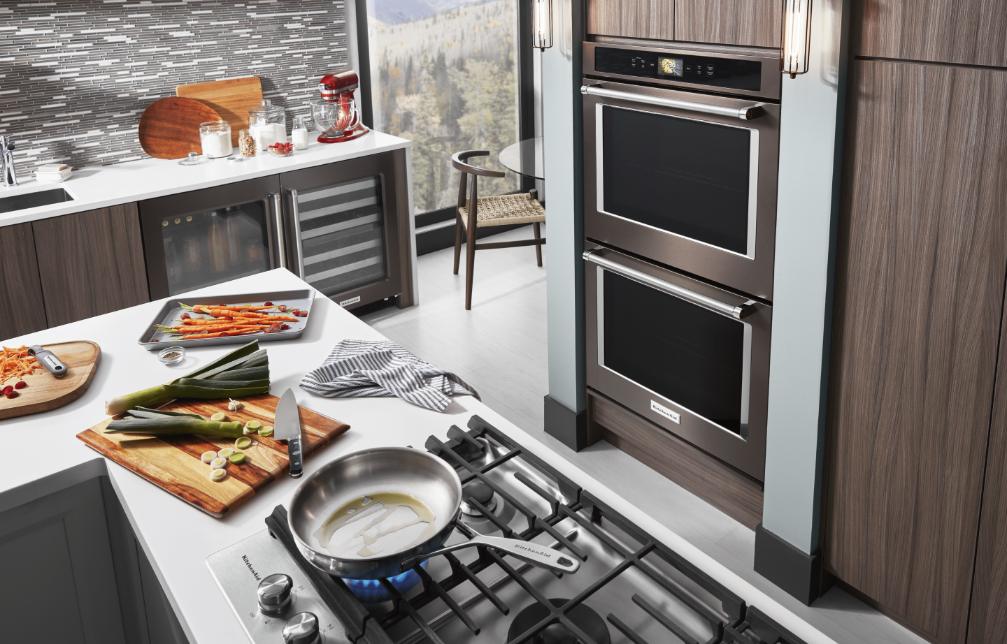 Black KitchenAid® double wall oven inside a sleek and modern kitchen Black KitchenAid® double wall oven inside a sleek and modern kitchen