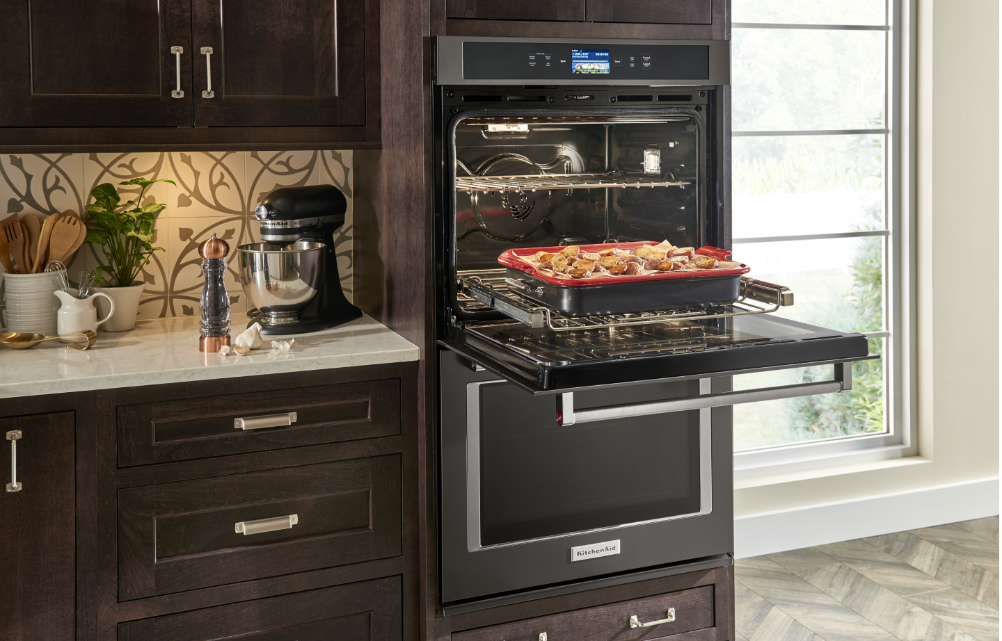 Open KitchenAid® double wall oven with a tray of potatoes on the rack  Open KitchenAid® double wall oven with a tray of potatoes on the rack