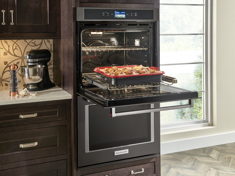 Open KitchenAid® double wall oven with a tray of potatoes on the rack  Open KitchenAid® double wall oven with a tray of potatoes on the rack