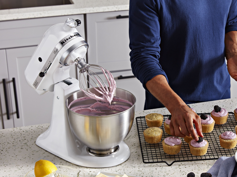Person using white tilt-head KitchenAid® stand mixer