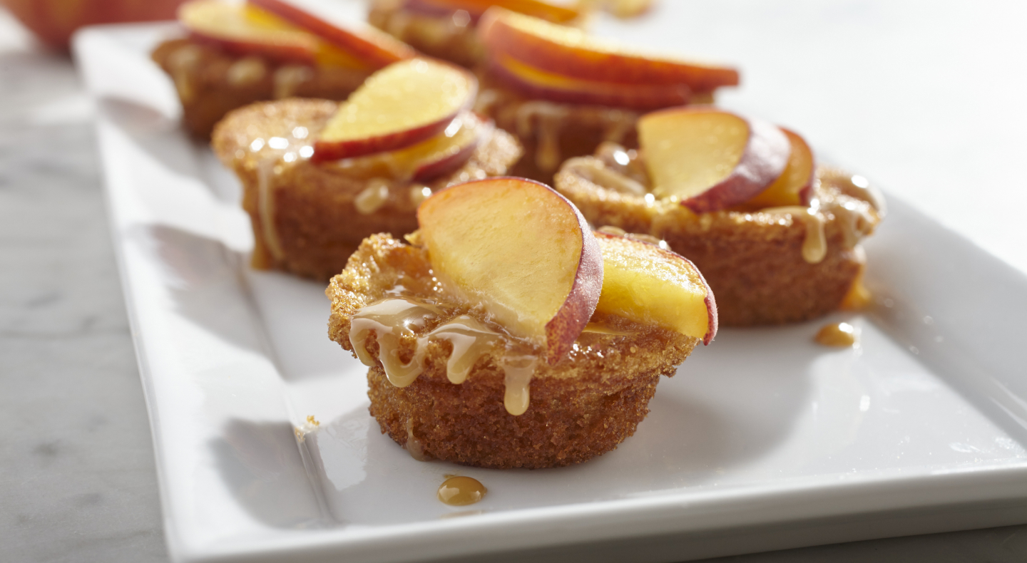 Muffins drizzled with caramel and topped with apple slices. Muffins drizzled with caramel and topped with apple slices.