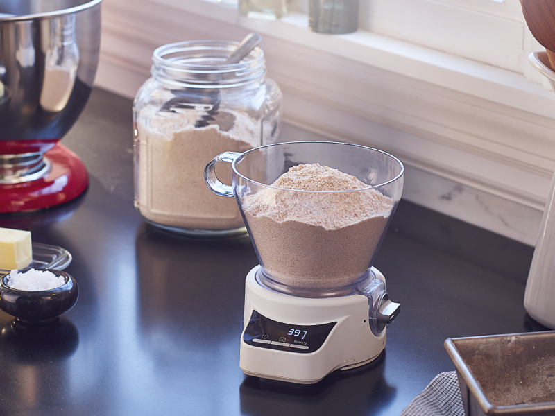 A container of flour being weighed. A container of flour being weighed.