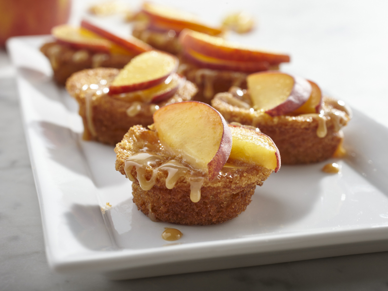 Muffins drizzled with caramel and topped with apple slices. Muffins drizzled with caramel and topped with apple slices.