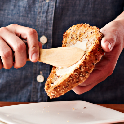 Toast being spread with margarine