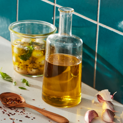 Oil in cruet with herbs and mozzarella balls