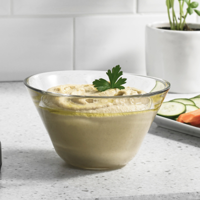 Hummus in clear glass bowl