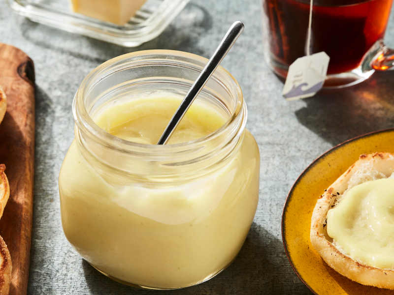 Jar of lemon curd with muffins Jar of lemon curd with muffins