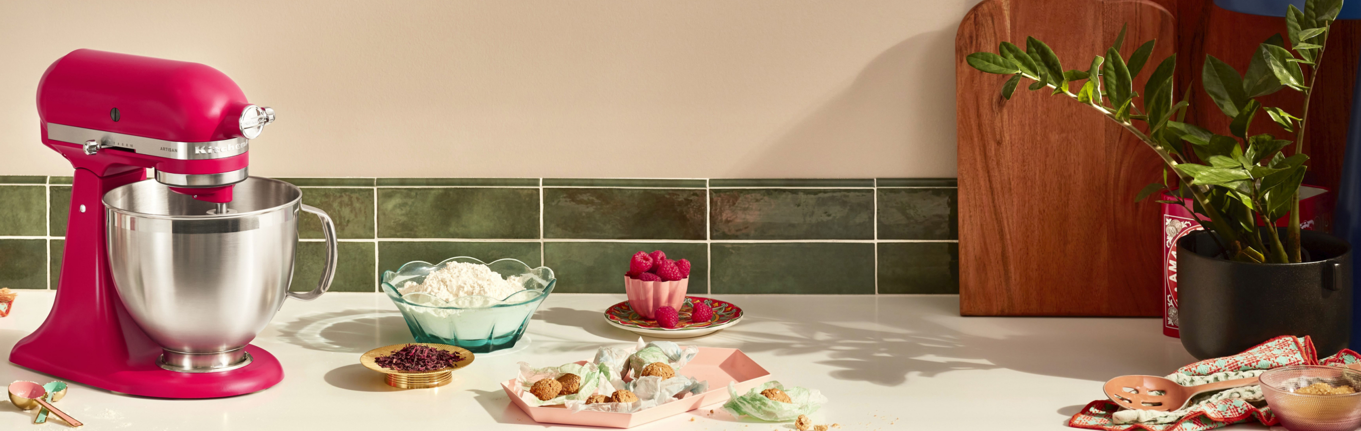 KitchenAid® stand mixer with stainless mixing bowl on countertop with ingredients