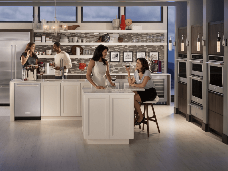 Four people sitting around a kitchen island Four people sitting around a kitchen island