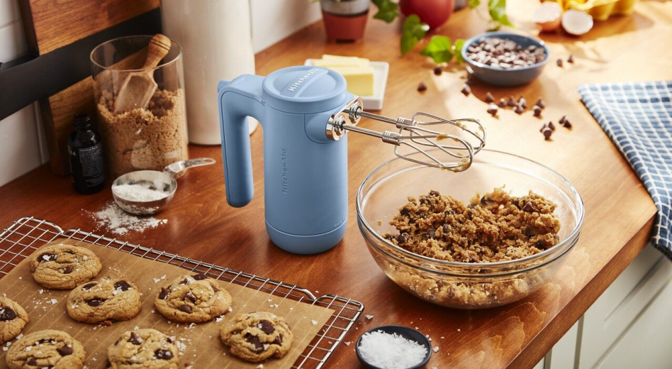 KitchenAid® hand mixer with bowl of cookie dough and wire rack with fresh baked cookies. KitchenAid® hand mixer with bowl of cookie dough and wire rack with  fresh baked cookies.