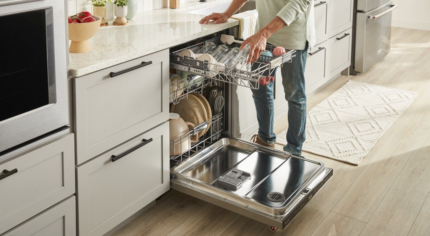 Man loading a dishwasher  Man loading a dishwasher