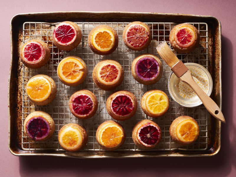 Citrus topped baked goods on cooking rack above cookie sheet Citrus topped baked goods on cooking rack above cookie sheet