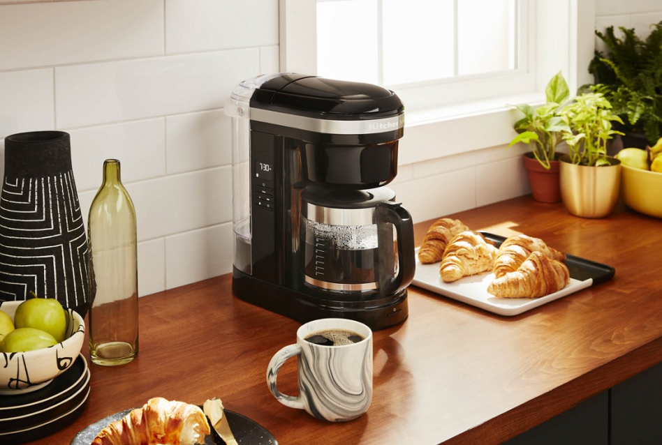 KitchenAid® auto drip coffee maker on counter with coffee and croissants KitchenAid® auto drip coffee maker on counter with coffee and croissants
