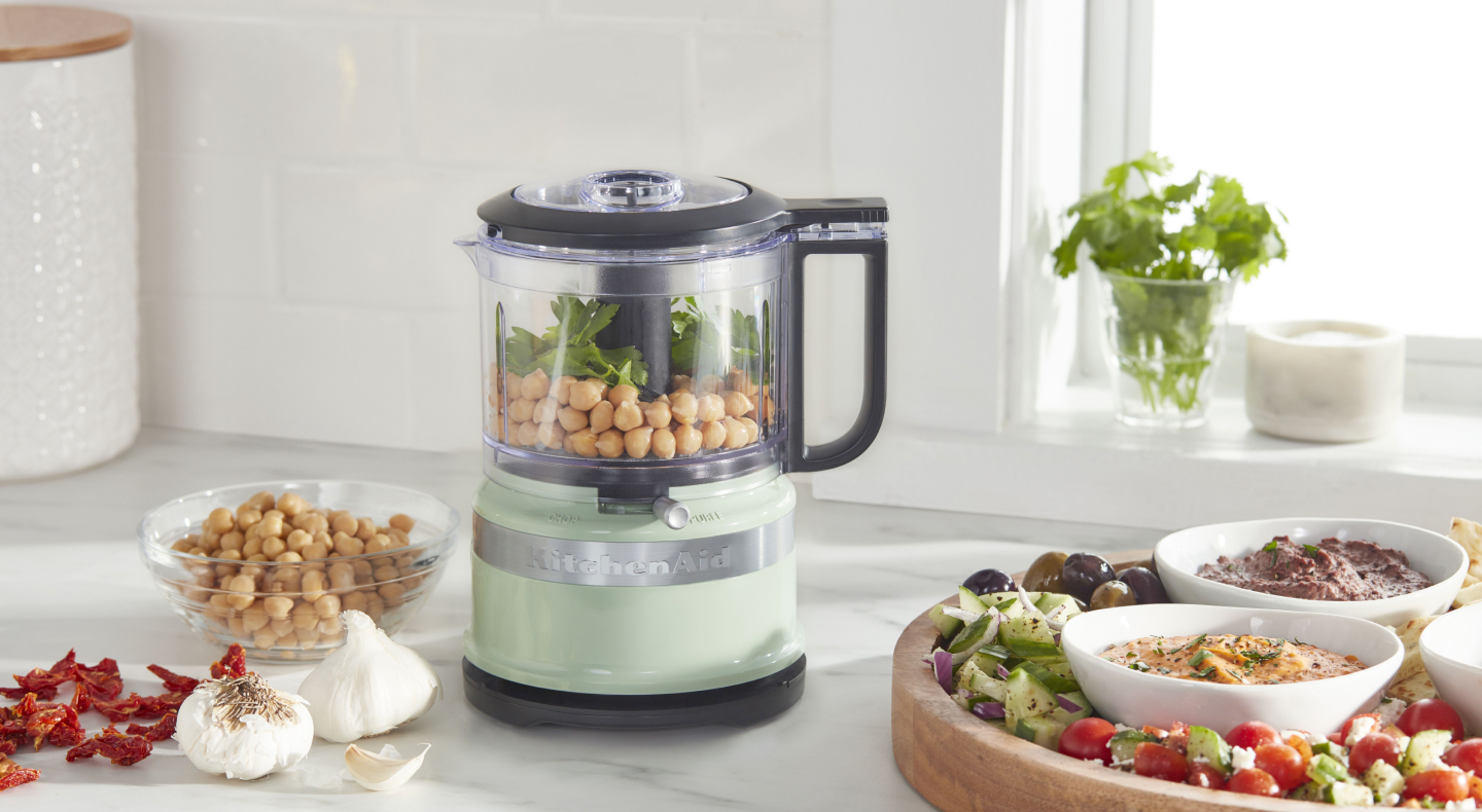 Chickpeas inside a mint green KitchenAid® food processor Chickpeas inside a mint green KitchenAid® food processor
