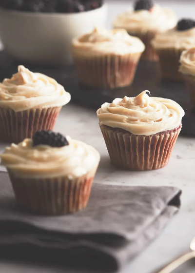Close-up of cupcakes with white frosting on a countertop