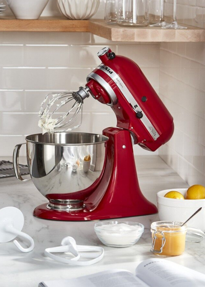 Red KitchenAid® stand mixer on granite countertop with batter on the whisk