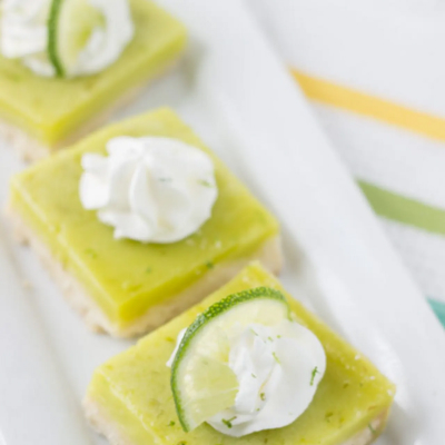 Coconut lime bars on white platter