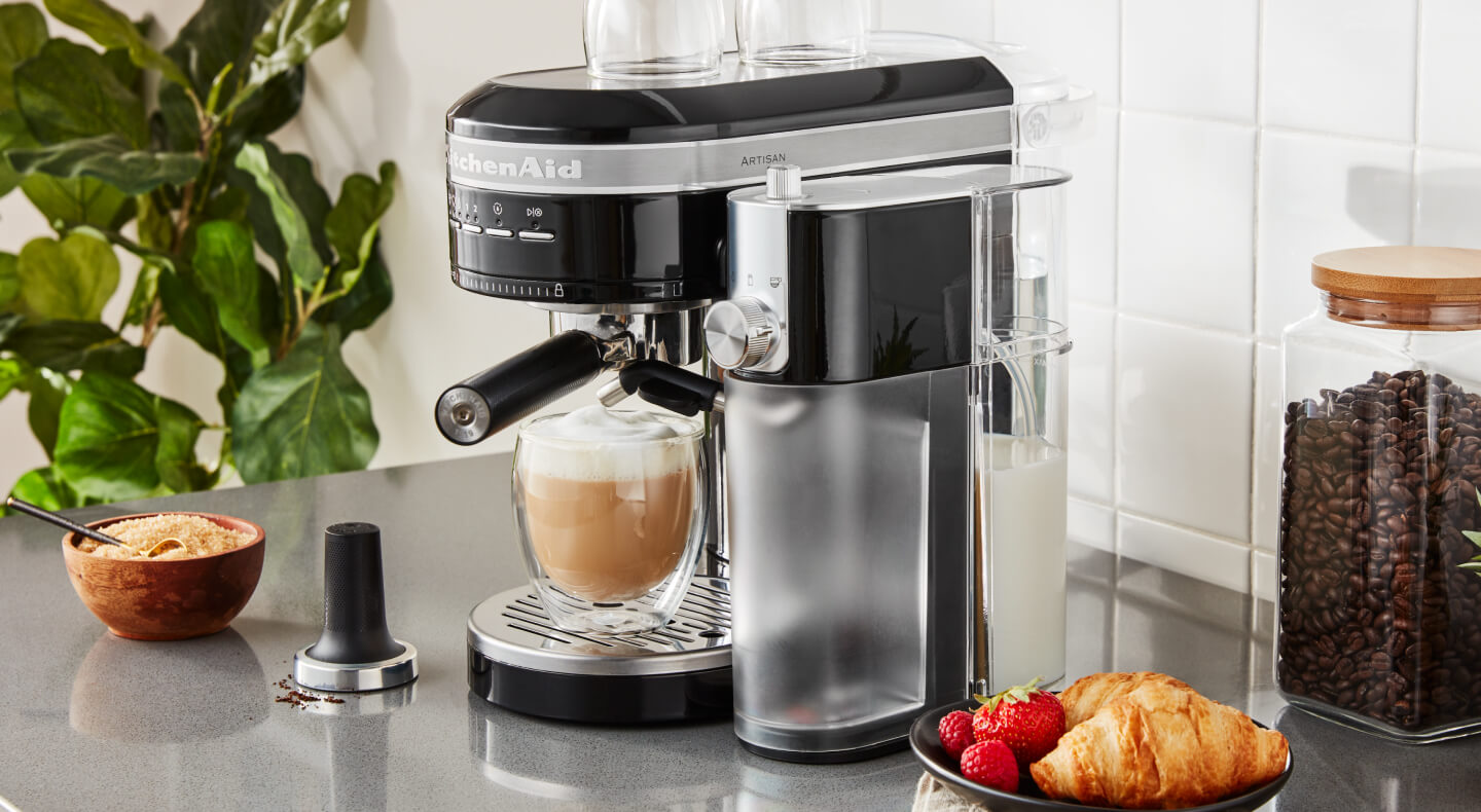 Black semi-automatic type of espresso machine with cappuccino on counter