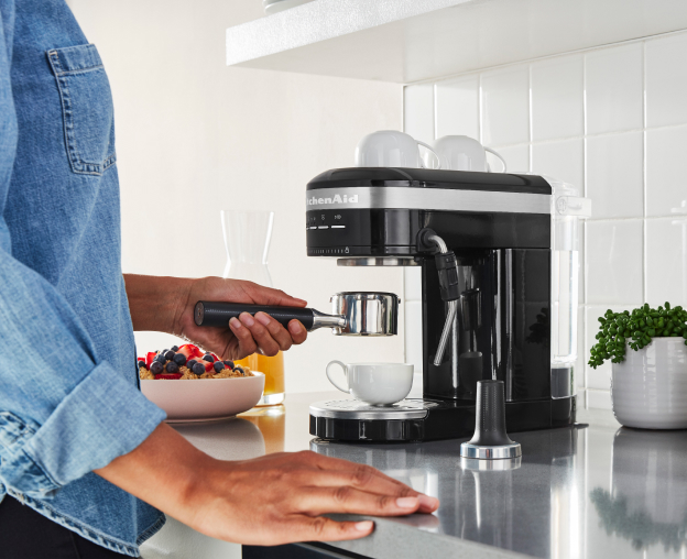 Woman using an espresso maker