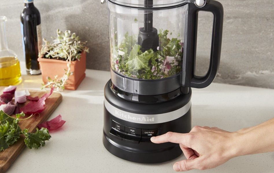 Red KitchenAid® food processor with salsa ingredients Black KitchenAid® food processor with salsa ingredients