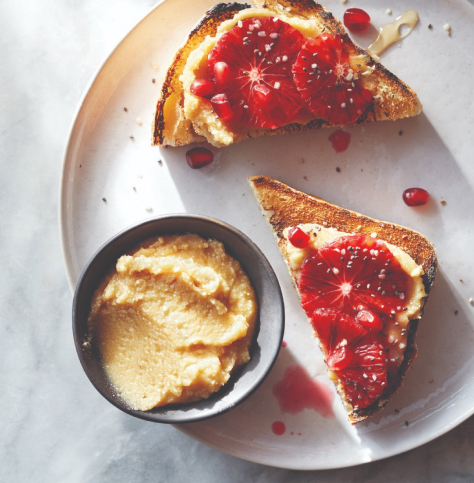 A top-down view of two pieces of toast with a fruit and nut butter spread. A top-down view of two pieces of toast with a fruit and nut butter spread.