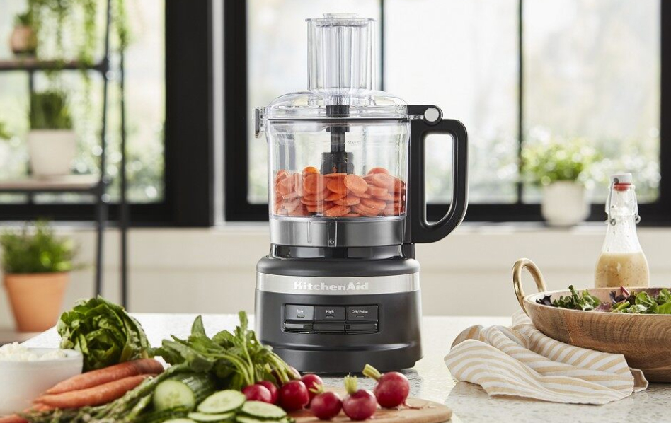 Black KitchenAid® food processor with sliced carrots and vegetables in bright kitchen Black KitchenAid® food processor with sliced carrots and vegetables in bright kitchen
